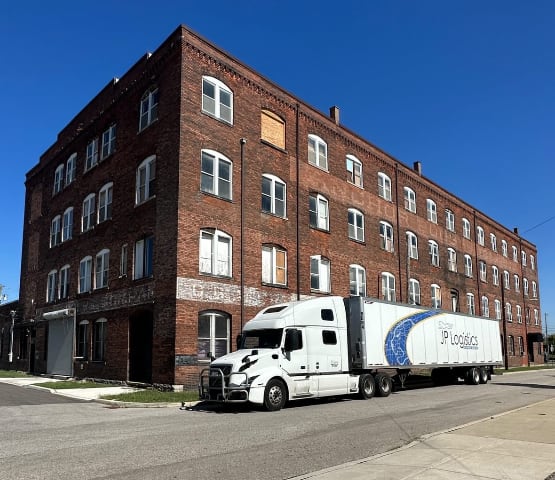 jp logistics truck near building